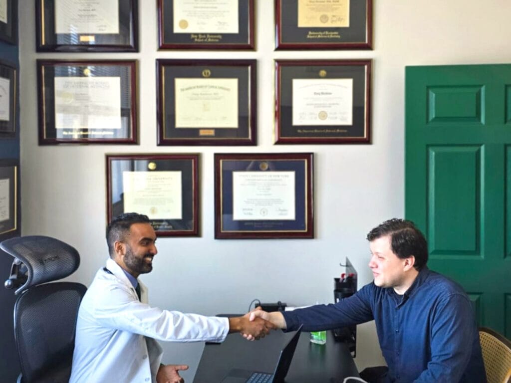 Dr. Mathews greets a patient with a warm handshake during a visit at Sequoia Medical 360, symbolizing trust, partnership, and a shared commitment to proactive care.